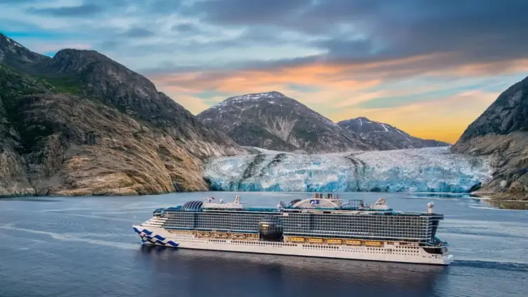 Cruise ship sailing past a tidewater glacier in an Alaskan fjord