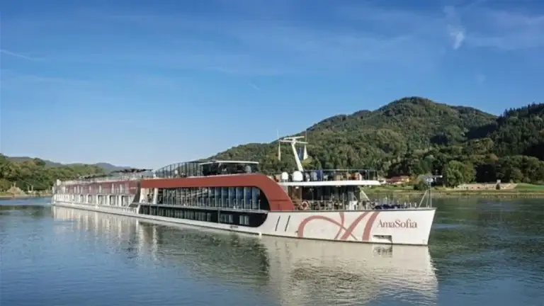 AmaWaterways river ship on a river lined with green hills