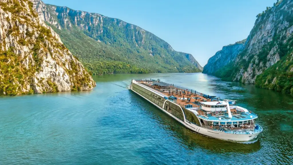 River cruise ship sailing through a dramatic river gorge