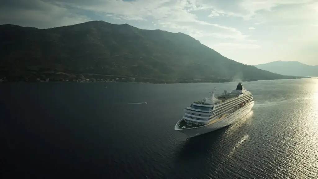 Crystal cruise ship sailing through a misty fjord