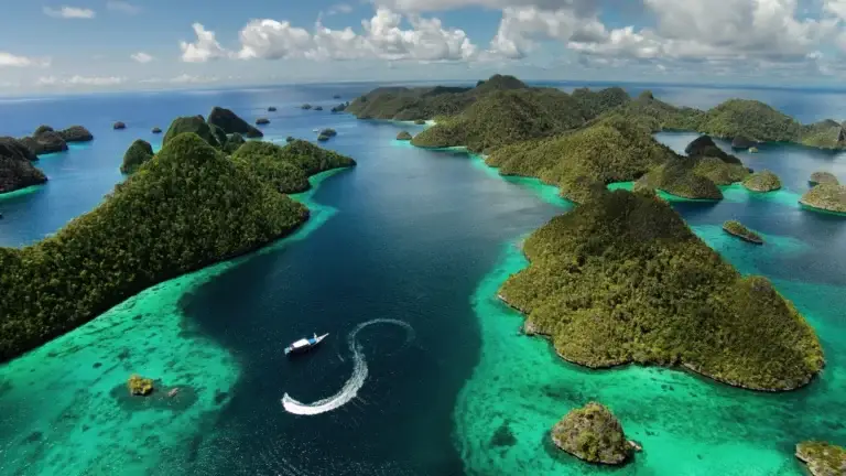 Aerial view of green limestone islets and turquoise lagoons in Raja Ampat, Indonesia