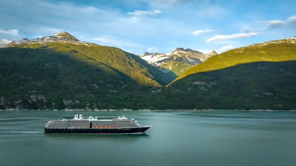 Holland America Line ship in an Alaskan fjord surrounded by mountains
