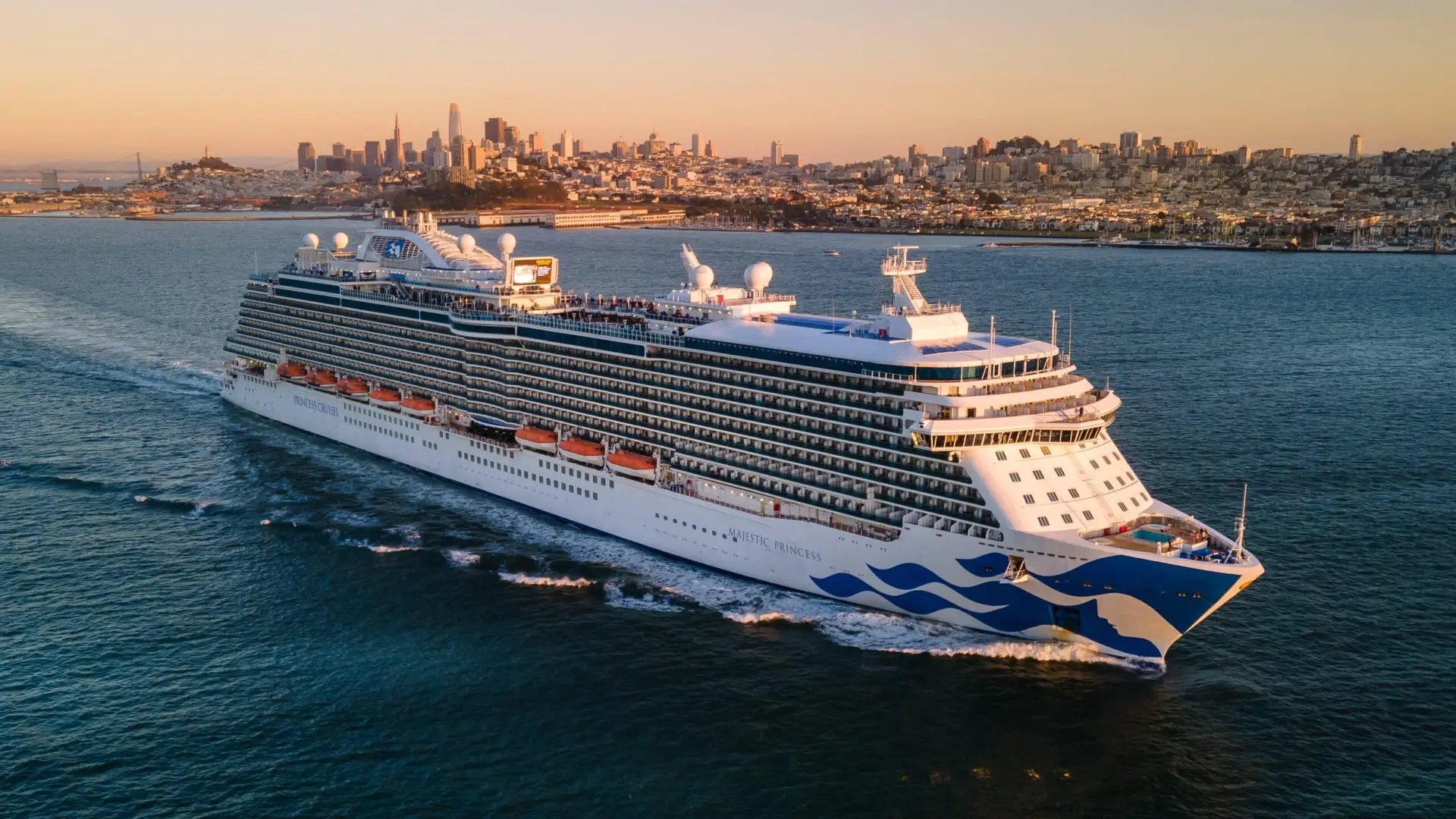 Majestic Princess cruise ship sailing past a city skyline