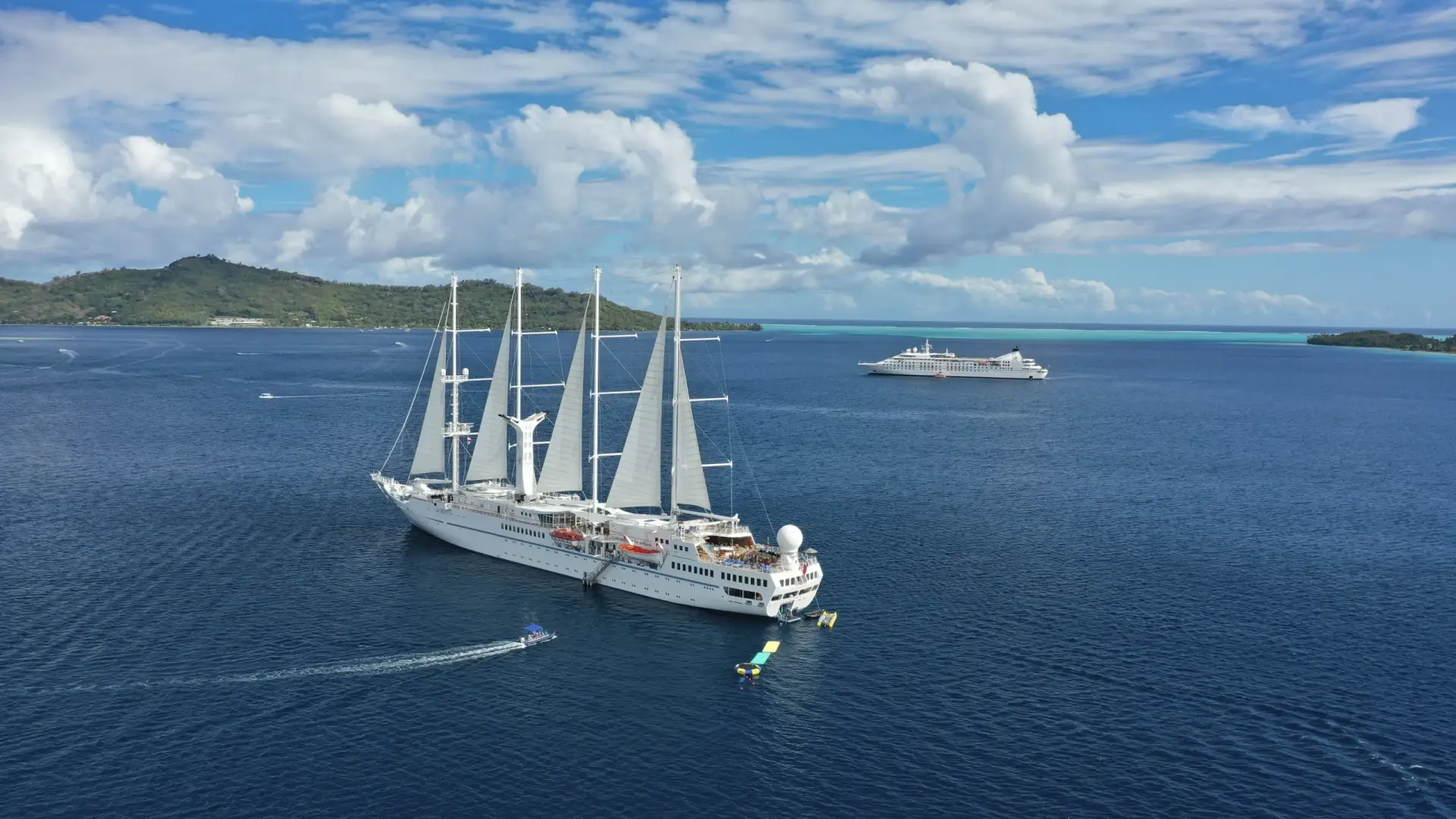 Windstar sailing yacht with white sails at sea
