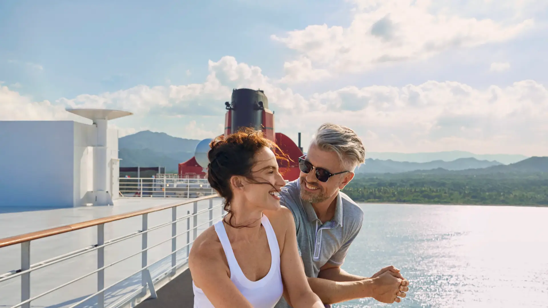Couple enjoying the view from a cruise ship balcony