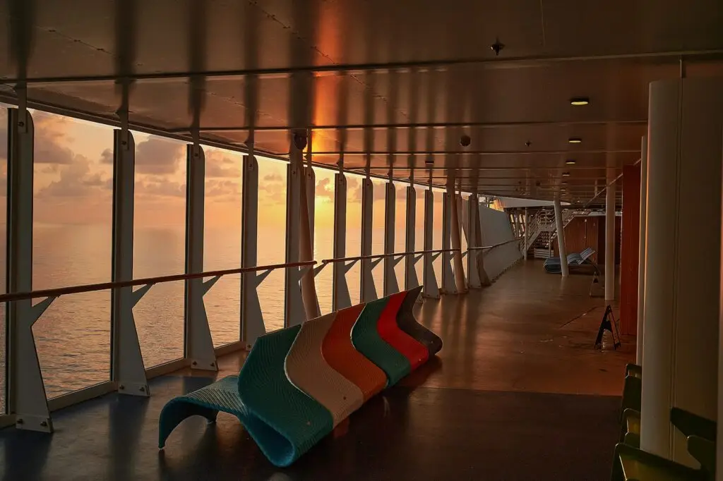 Lounge chairs on a cruise ship deck in golden light
