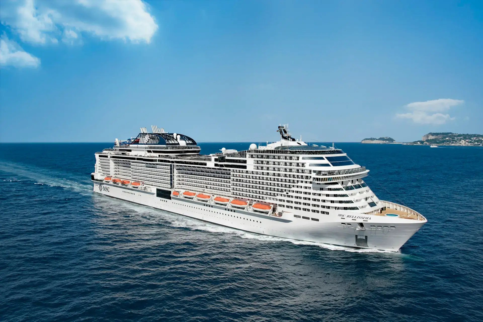 Large cruise ship sailing on a deep blue ocean