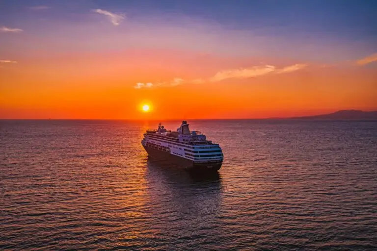 Cruise ship sailing at sunset