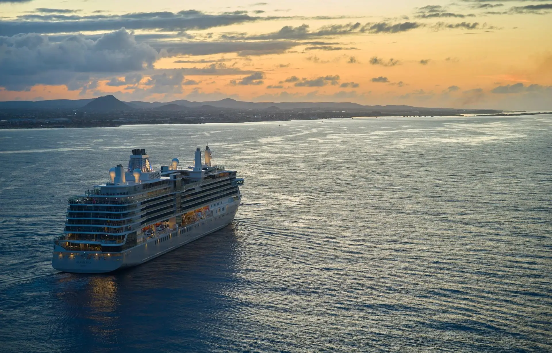 Luxury cruise ship sailing at sunset